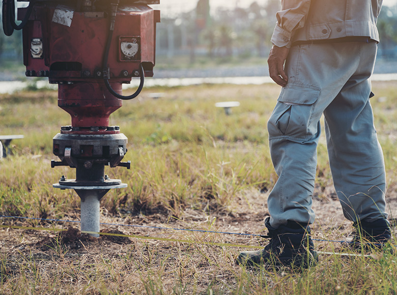 workers are drilling holes for screws